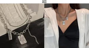 Silver double-layer pendant necklace with engraved rectangular tags and curb chain links