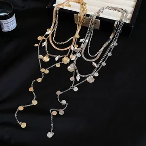 Bohemian multi-layer necklace with metal shell pendant and sequins in gold and silver finish