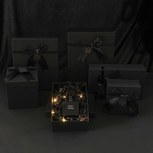 Matte black kraft gift box with silk ribbon and warm LED lights for luxury packaging