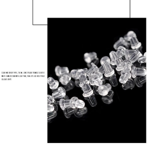 Macro shot of transparent silicone earring backings on a reflective black background
