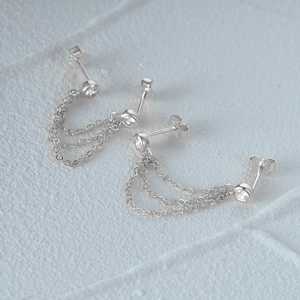 Detail of S925 sterling silver chain earrings with cz studs and elegant tassels