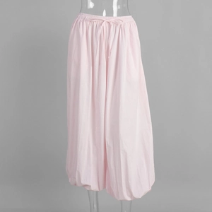 Detail of light pink cotton balloon pants showing elastic waist and drawstring design