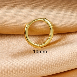 Close-up of 10mm golden hoop earrings on silk background with polished finish