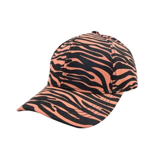 Detail view of bold orange and black animal print baseball cap with striped pattern