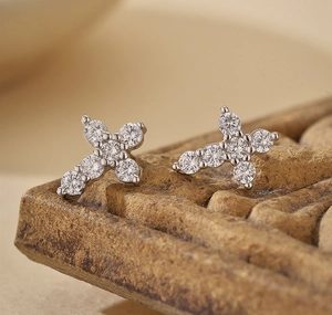 Macro view of S925 silver cross earrings with round brilliant cut cubic zirconia gems