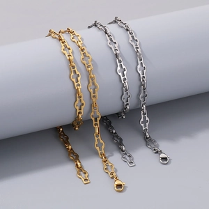 Detail of minimalist stainless steel cross link necklaces in gold and silver finishes