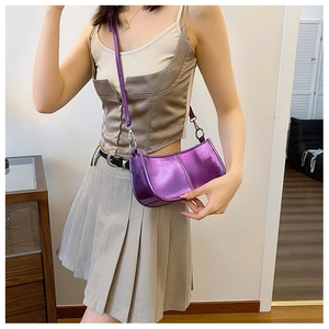 Close-up of shiny purple metallic PU leather shoulder bag with silver hardware details