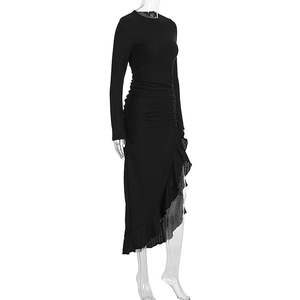 Detail of black long sleeve dress with waist ruching and asymmetrical ruffle hem