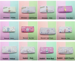 Macro display of assorted dinosaur, mermaid, and rabbit pencil cases in diverse colors