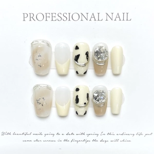 Detail of press-on nails set featuring coffee marble patterns and luxury rhinestones