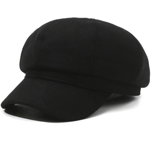 Detailed close-up of a classic black baker boy hat showing premium wool texture and seams