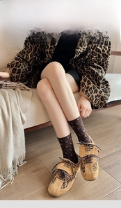 Close-up of leopard print mid-tube socks with cotton fabric and reinforced heel design