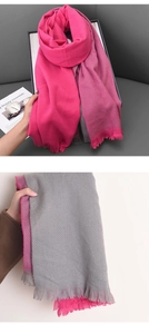Close-up of double-sided pink and grey cashmere pashmina shawl with fringe tassels