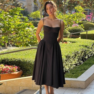 Detail of a black French vintage sundress with fishbone corset and slim waist design