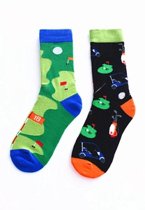 Detail view of golf-themed mismatched cotton socks with green course map and cart patterns