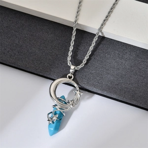 Detail of blue hexagonal stone pendant with silver moon and star wire-wrapped design