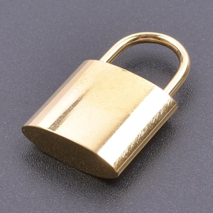 Macro shot of a polished golden stainless steel padlock charm with a smooth metallic finish