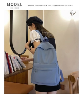 Blue large capacity backpack with front pocket shown in a lifestyle campus scene