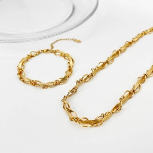 Detail of 18k gold plated flat snake chain necklace set with twisted oval link accents