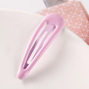 Detailed close-up of a smooth lavender candy-colored teardrop BB hair clip on a marble tray
