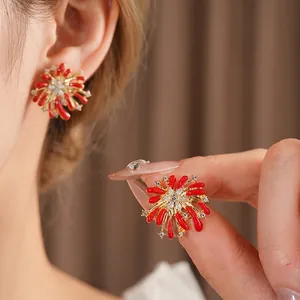 Elegant firework-shaped stud earrings featuring red coral motifs and sparkling zircons