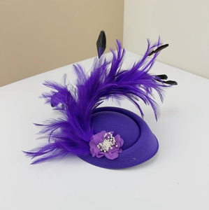Elegant vintage purple fascinator hat with large feathers and pearls for weddings