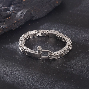 Detailed close-up of a silver Byzantine chain bracelet with a punk-style toggle clasp