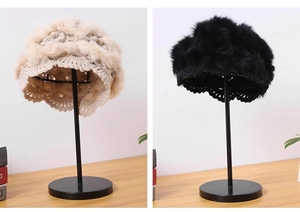 Detailed comparison of beige and black hand-crocheted rabbit fur knit hats on stands