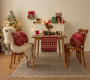 Detailed view of red Christmas table runner with reindeer and snowflake patterns
