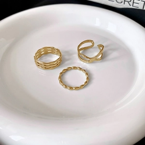 Detailed view of three gold-plated vintage rings featuring hollow weave and beaded designs