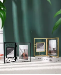 Detail of modern black and gold metal folding photo frames with geometric wire patterns