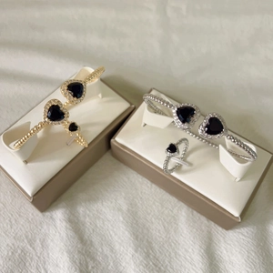 Detailed view of gold and silver heart-shaped jewelry sets with micro-set zircon accents