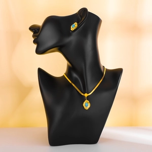 Bohemian gold jewelry set with oval turquoise inlay featuring necklace and earrings