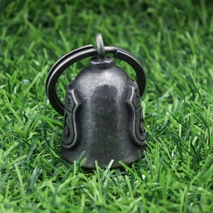 Detailed close-up of retro silver Route 66 guardian bell for motorcycles on grass