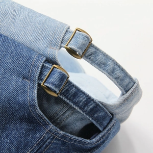 Close-up of denim baseball caps in light and dark blue with bronze metal buckles