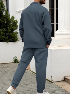 Rear view of dark grey-blue men's tracksuit featuring waffle texture knit and ribbed cuffs