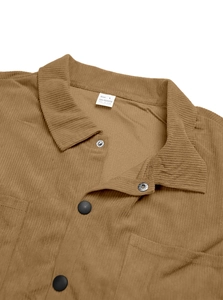 Detail of tan corduroy shirt showing collar, buttons, and high-quality fabric texture