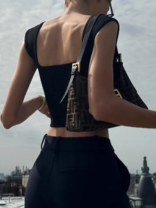 Chic retro monogram shoulder bag with canvas finish and gold clasp shown on model