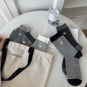 Striped cotton socks set with bear embroidery and matching canvas tote bag on white table