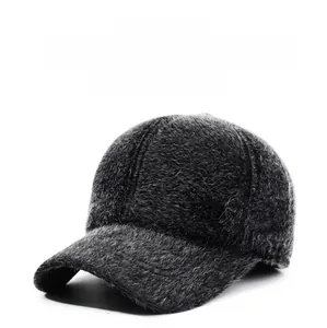 Detail of warm faux fur texture and golden metal badge on this winter baseball cap