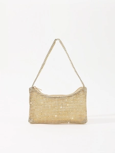 Close-up of sparkling gold rhinestone mesh and zipper detail on evening underarm bag