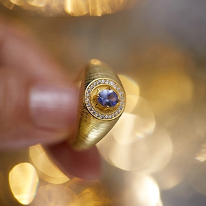 Close-up of S925 sterling silver ring with blue tanzanite and brushed gold finish