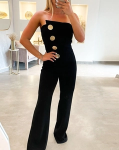 Detail view of black tube top jumpsuit with vintage gold buttons and flare leg fit