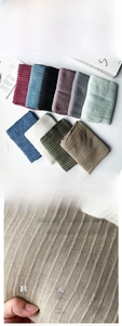 Close-up of soft modal scarf with vertical cable knit texture in multiple colors