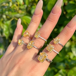 Elegant S925 silver rings featuring heart and oval yellow gemstones in outdoor setting