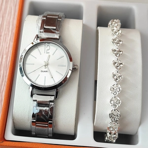 Silver quartz watch and heart link bracelet set with rhinestones in an orange gift box