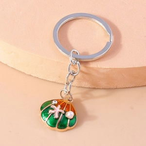 Detailed view of enamel shell keychain with pink starfish and white pearl accent