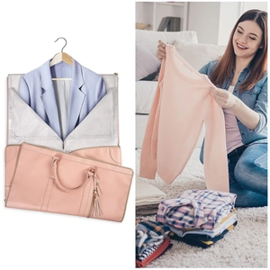 Pink folding garment bag showing suit storage functionality and stylish travel design