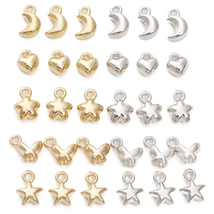 Mix of metallic star heart moon and butterfly charms in gold and silver plating