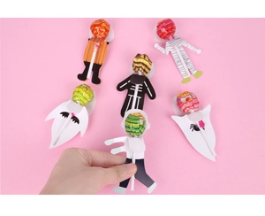 Macro detail of Halloween lollipop paper cards with cute ghosts and mummy designs